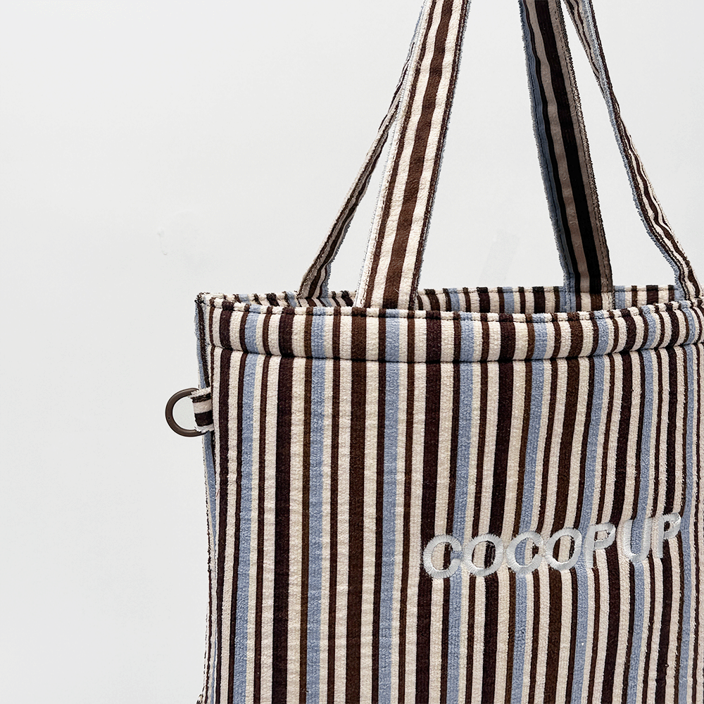 Brown, white and blue striped Tote Bag with D-Ring on side.