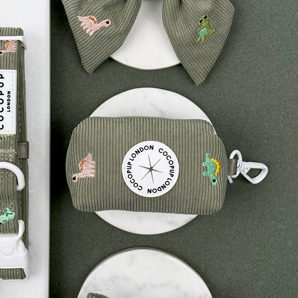 Green corduroy material Dog Poop Bag Holder with embroidered dinosaurs. 