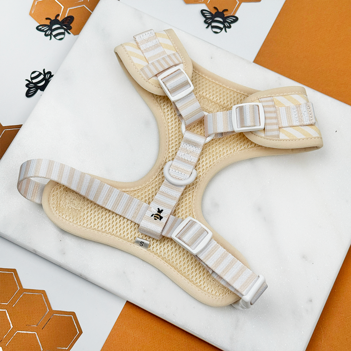 Pale yellow and white striped Dog Harness with bee and honeycomb embroidered decals. 