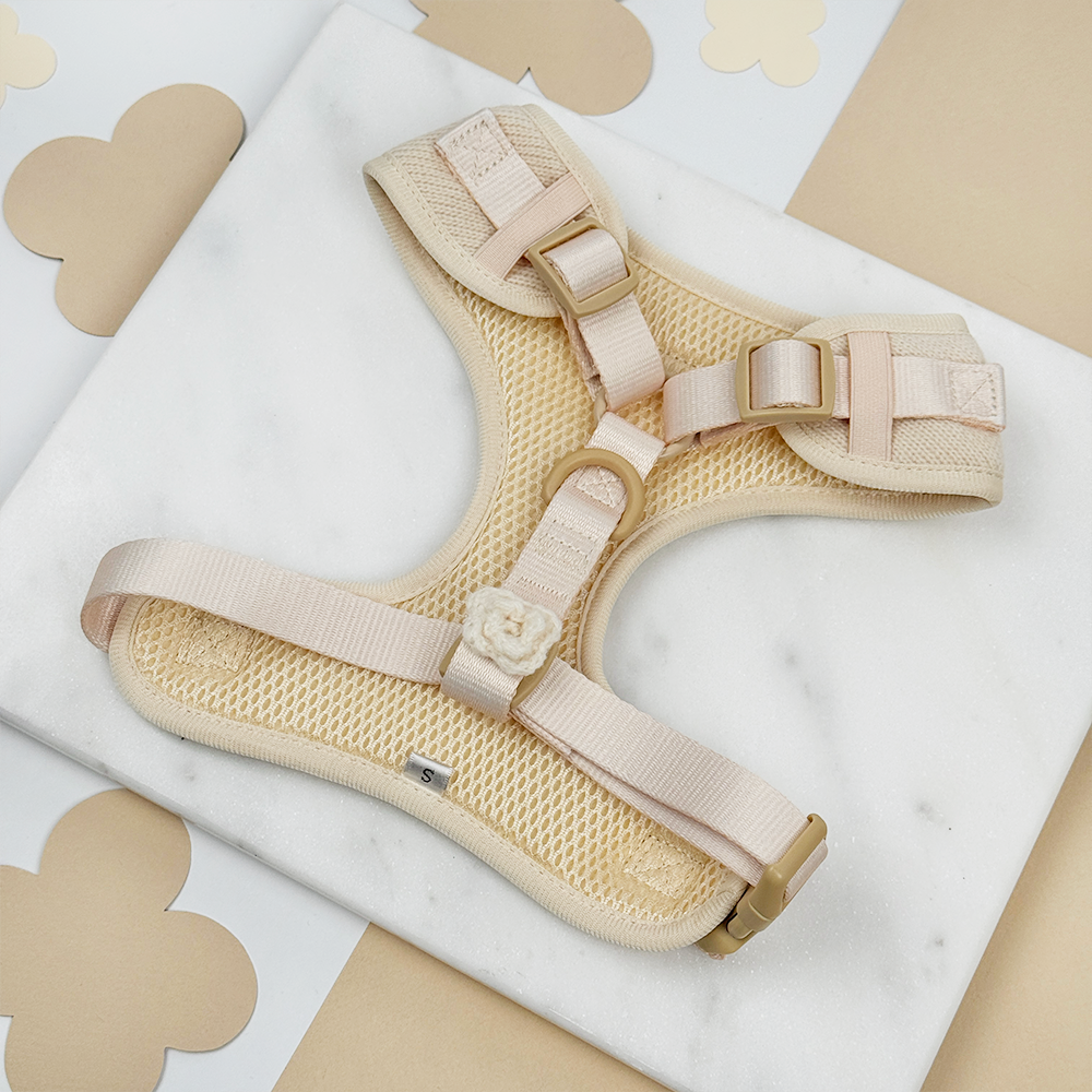 Beige Dog Harness on a white marble background.