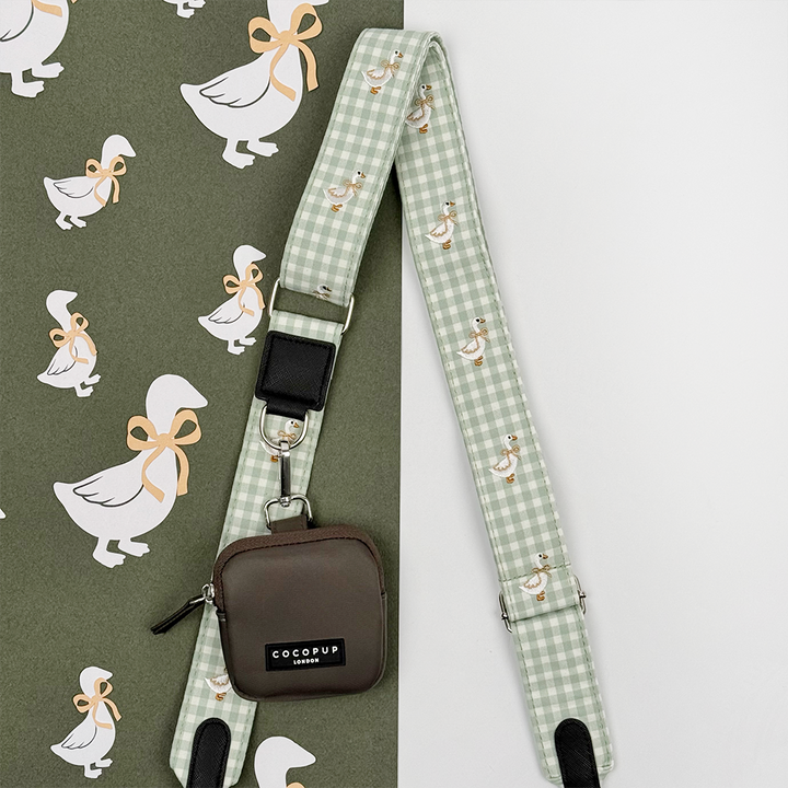 Green and white check print bag strap with embroidered geese design.