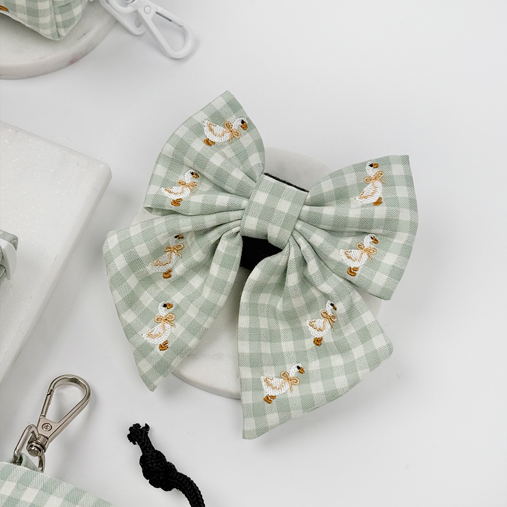 Green and white check print dog sailor bow tie with embroidered geese design.