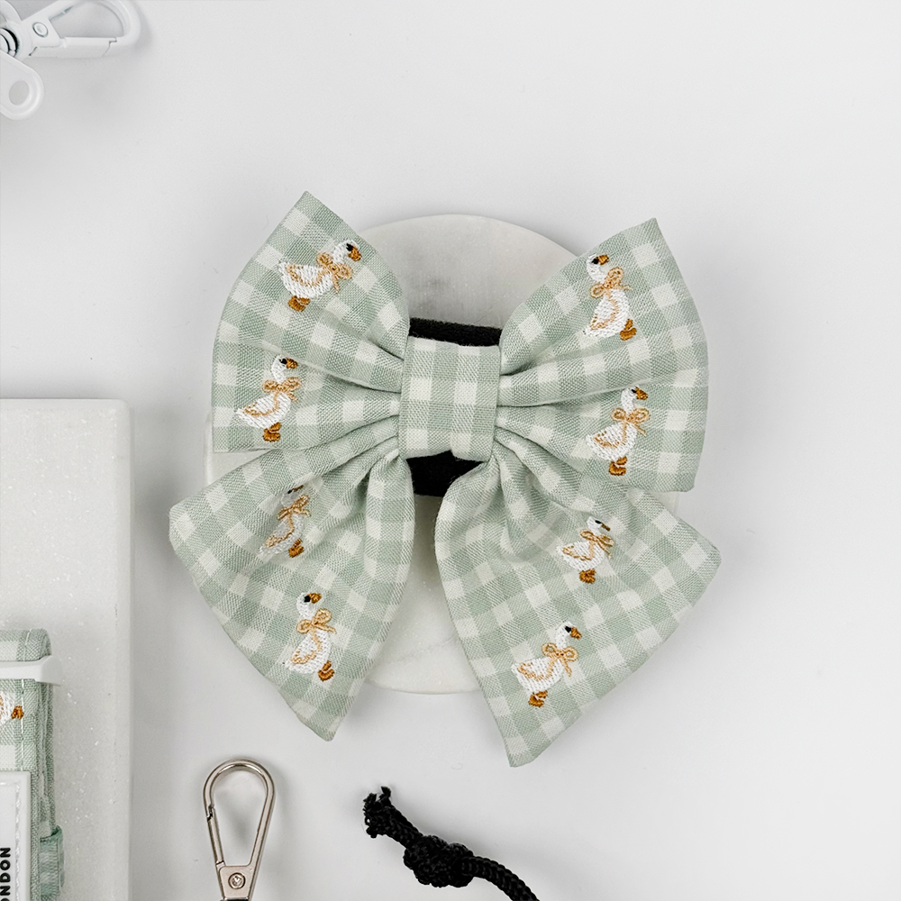 Green and white check print dog sailor bow tie with embroidered geese design.