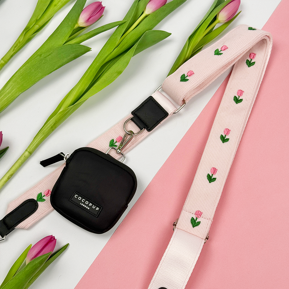 Pink Bag Strap with tulip embroidery design, attached to this is a black Cocopup Treat Pouch.