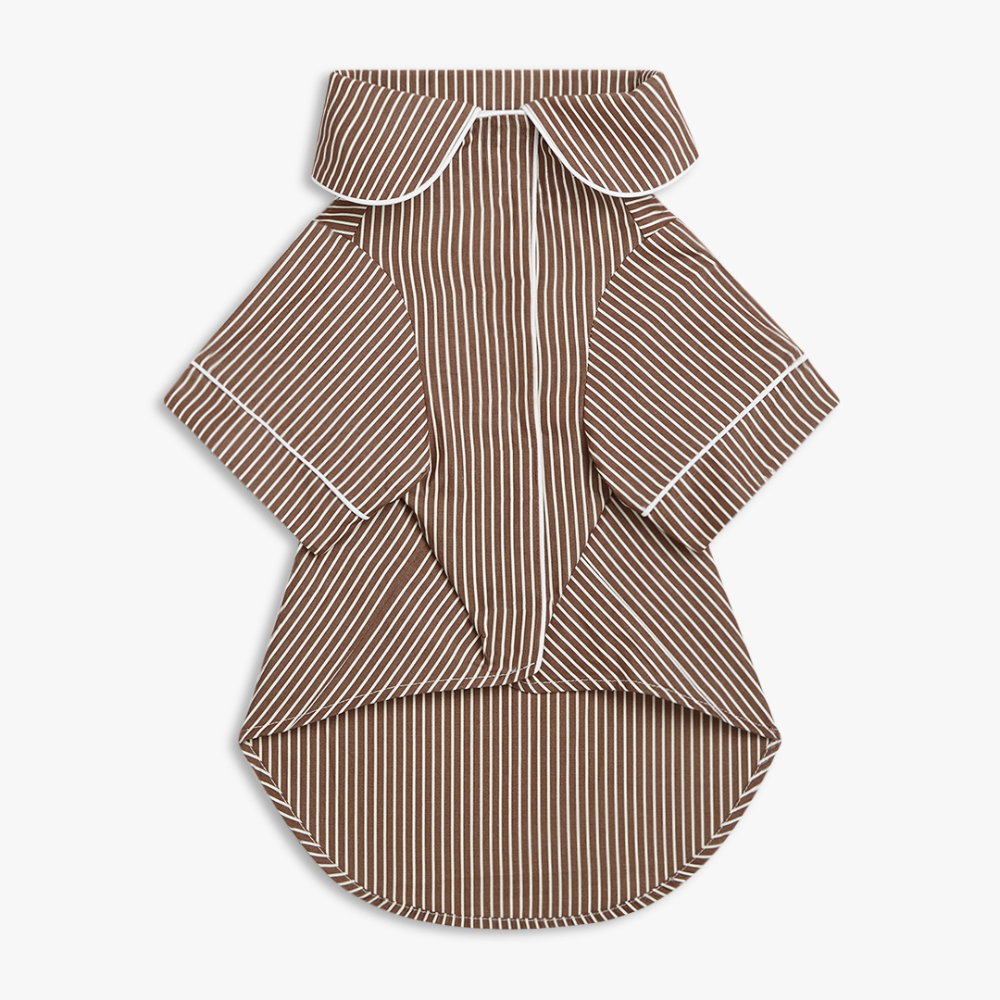 A dog shirt with a brown and white vertical stripe pattern, featuring a large collar and white piping details on the sleeves and collar, displayed flat against a light gray background.